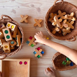 Weidenkörbe gefüllt mit Bauspiel X-Klötzen Bausteinen, Funkelsteinen und Lichtbauwürfel. Ein Kind spielt mit dem offenen Material.